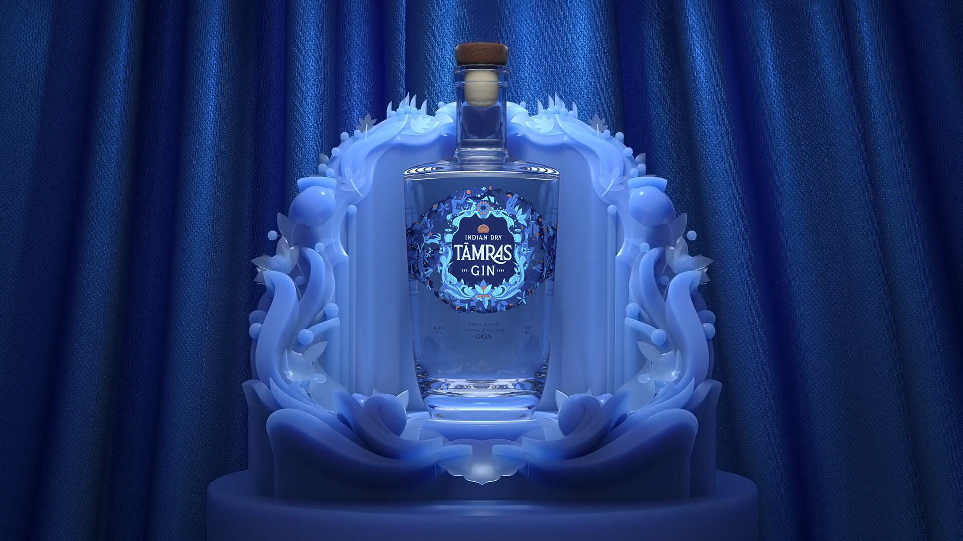 Tamras Gin bottle placed on an ornate blue stand in front of a blue curtain